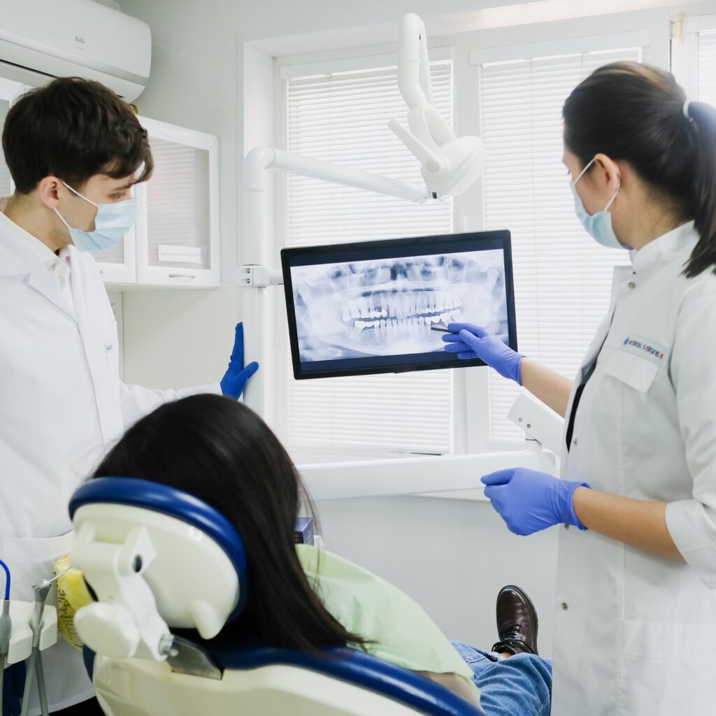 Dentist reviewing dental x rays with a patient during a free second opinion at Great Smiles Buford Center in Buford GA